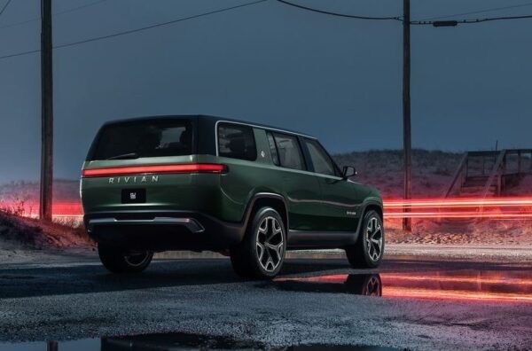 1st Generation Rivian R1S electric SUV three seated close rear view