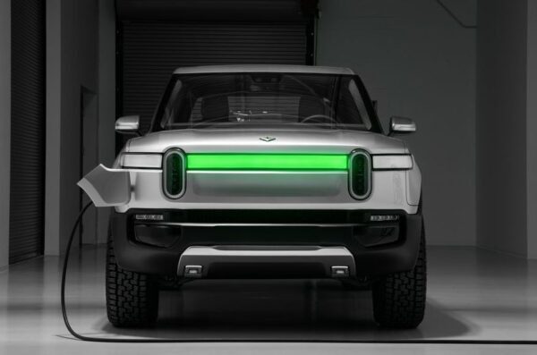 1st Generation Rivian R1T electric pickup truck front close view with charging light