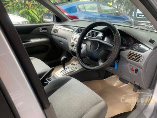 6th generation Mitsubishi Lancer sedan steering wheel and controls view