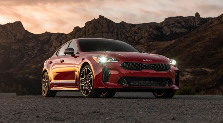 Kia stinger sedan Refreshed 1st generation red front with headlights on