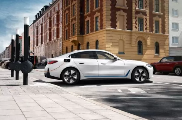 BMW i4 EV 1st generation sedan full side view and charging