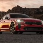 Kia stinger sedan Refreshed 1st generation red front with headlights on