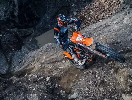 KTM 450 EXC enduro off road motorcycle moving upward on steep path